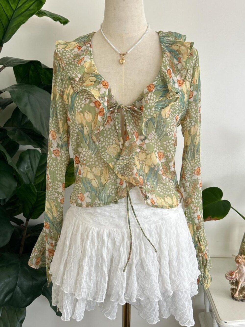 Green floral tie front blouse with ruffled hem